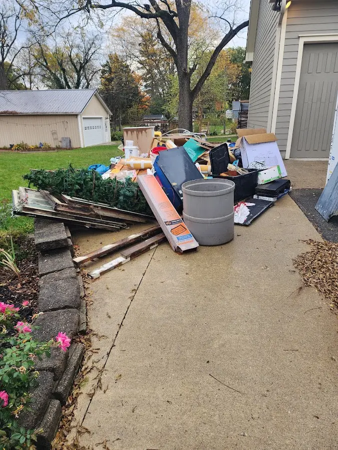 Dumpster being loaded with debris for 3 Yard Dumpster Rental in Audubon